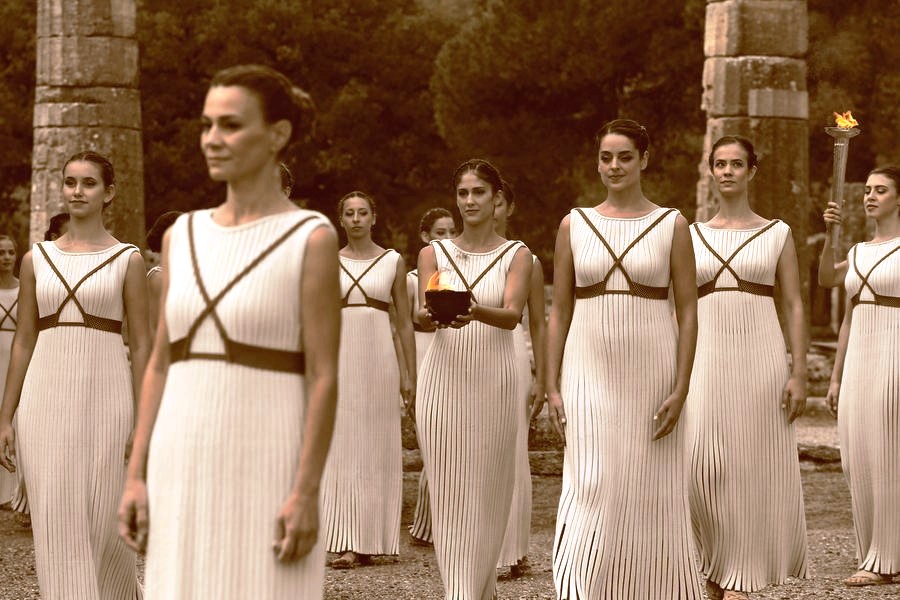 A group of priestesses in front of the Temple of Hera at Olympia. They carry the Olympic Flame.